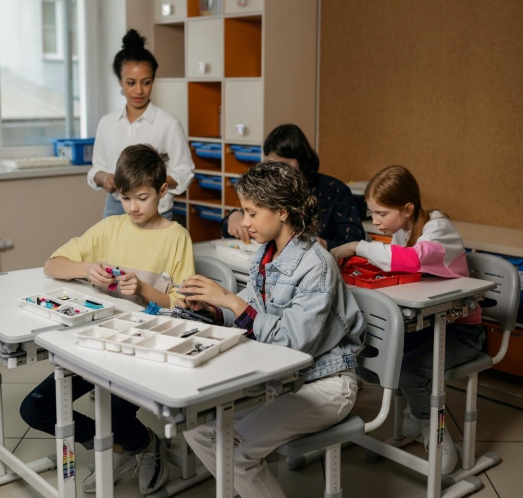 Imagem ilustrativa de uma professora e alunos na sala de aula aplicando algumas das vantagens da educação 5.0
